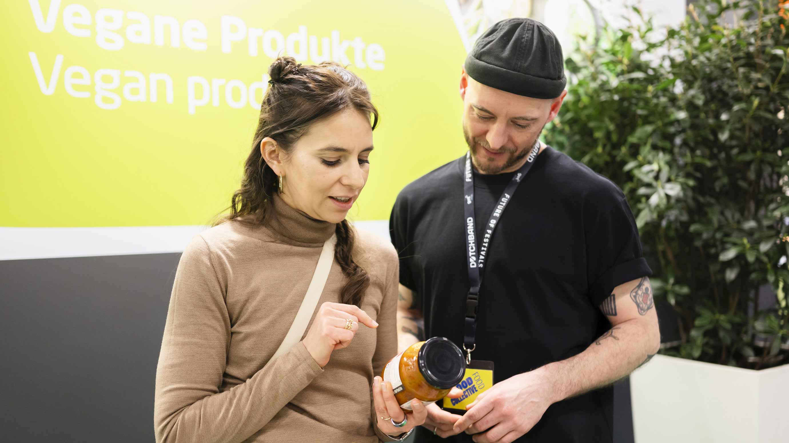 Two people look at a product at BIOFACH