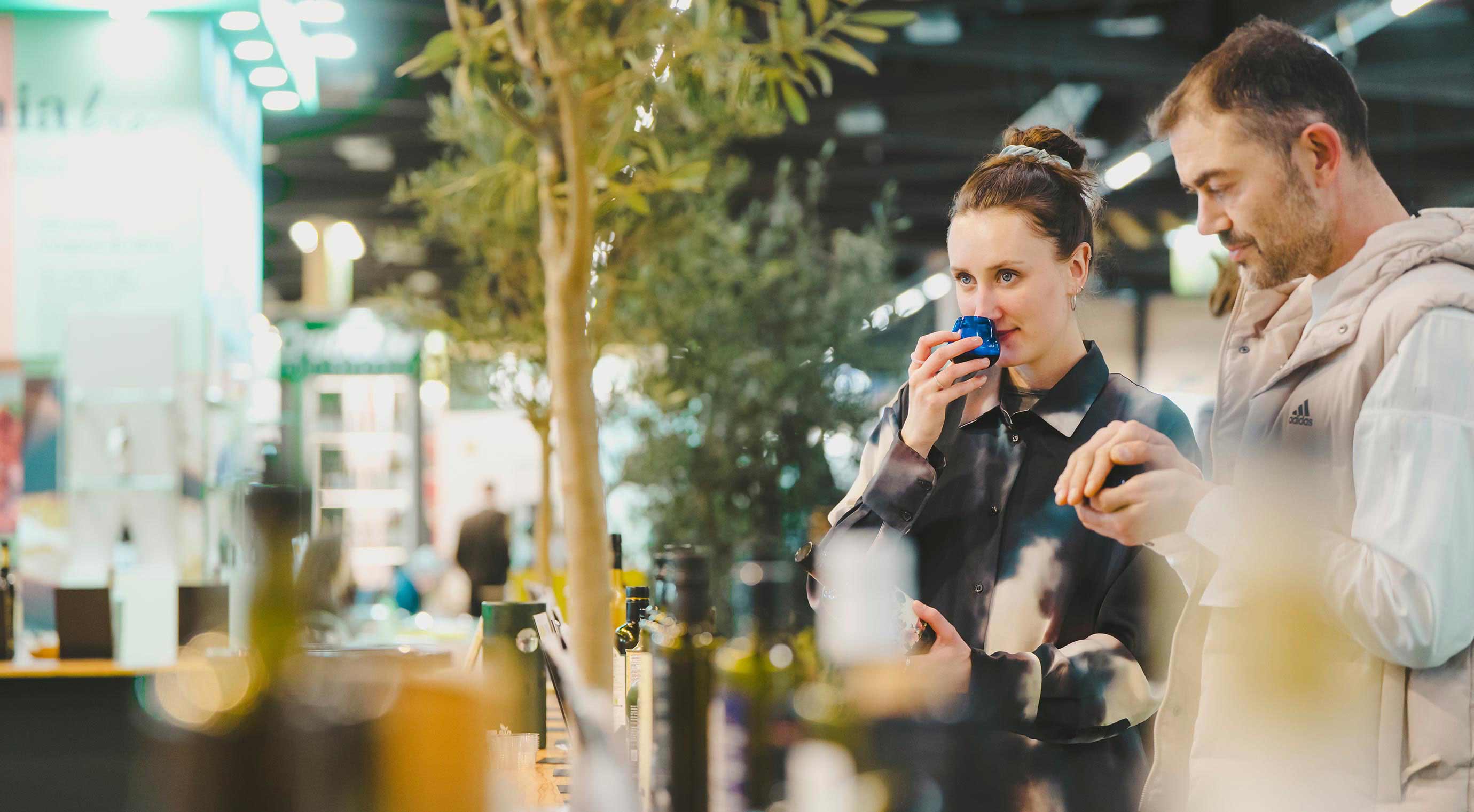 Two people test a product at the special area Experience the World of olive oil