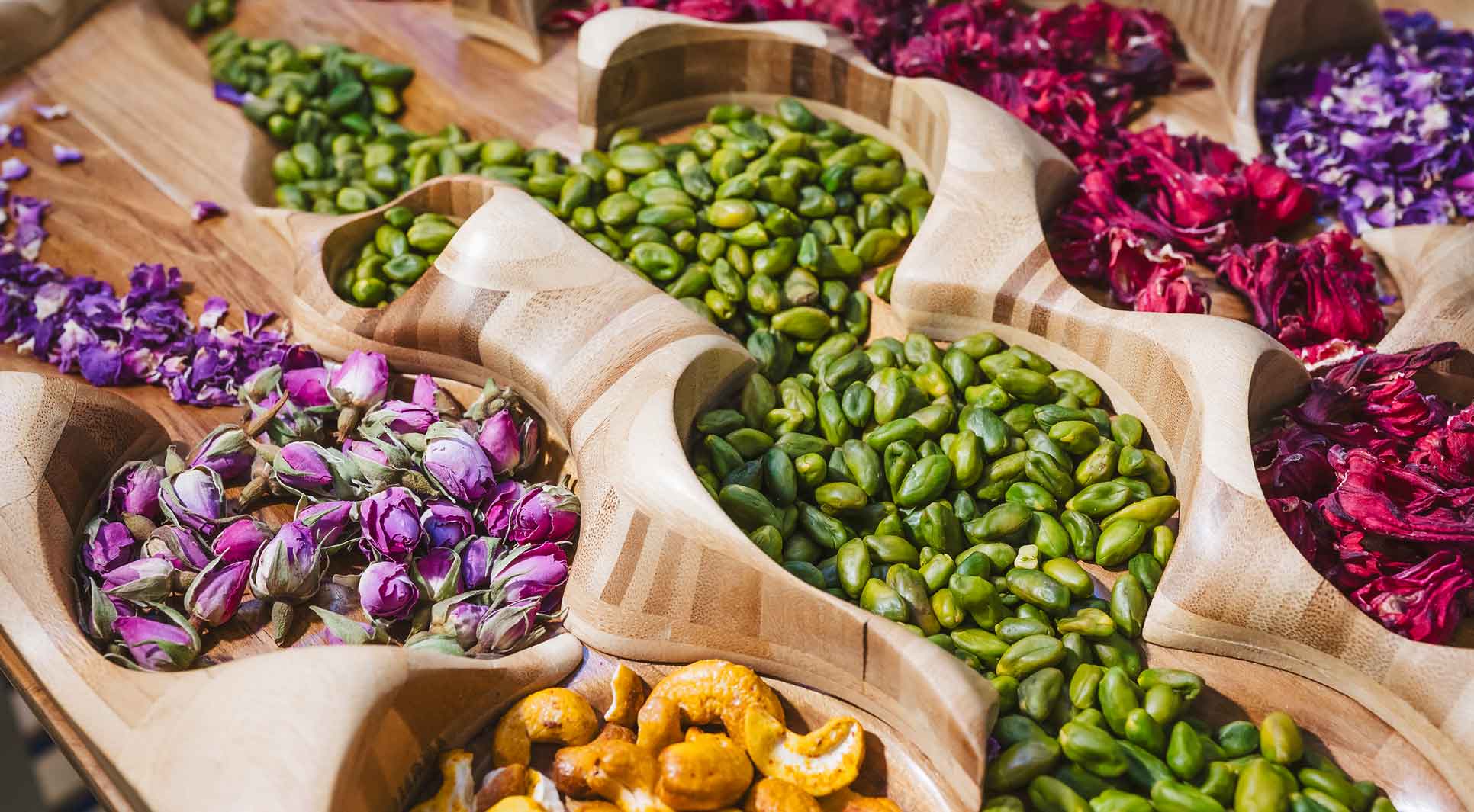 Flowers and nuts in a wooden bowl