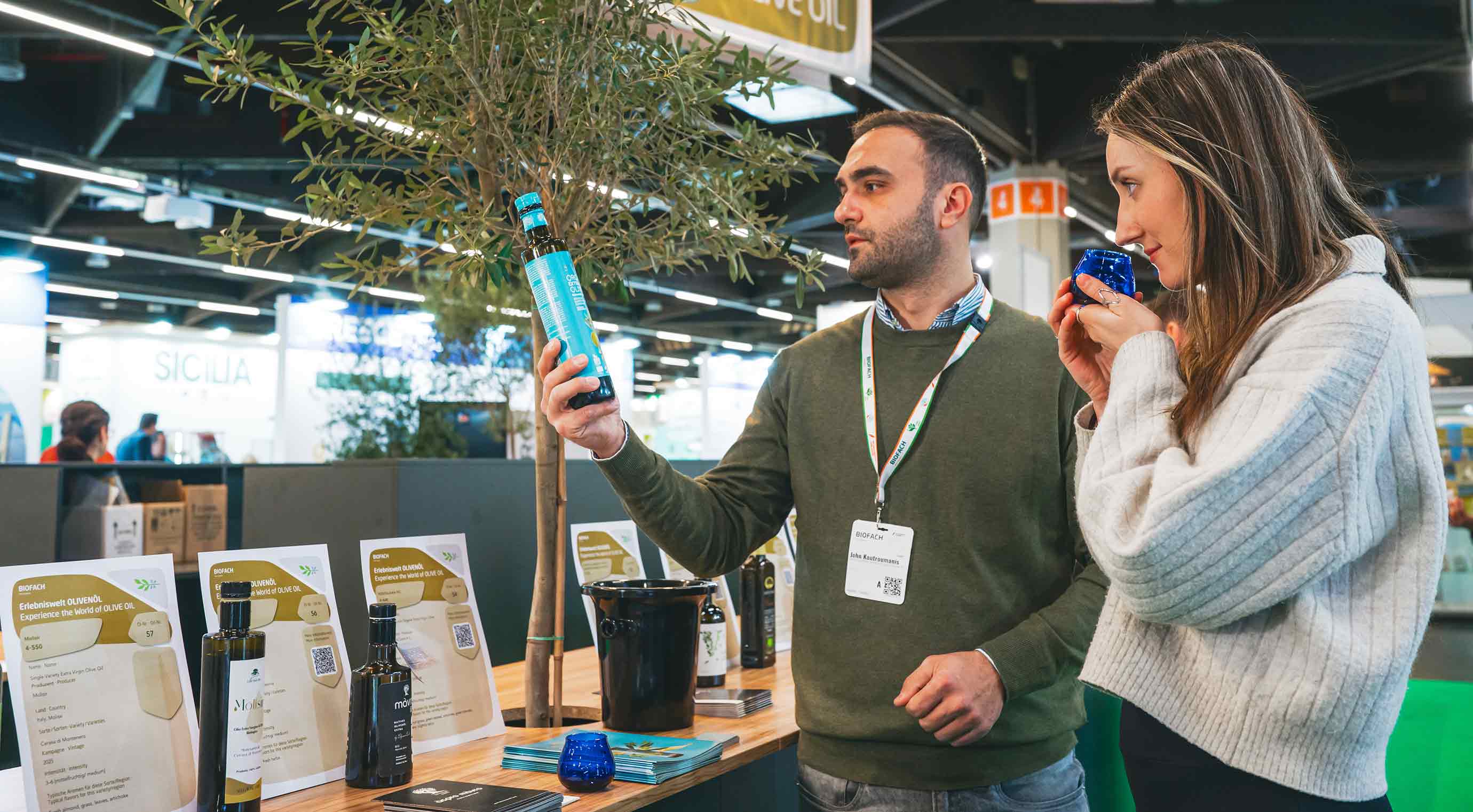 Two people tasting olive oil at Experience the World of Olive Oil