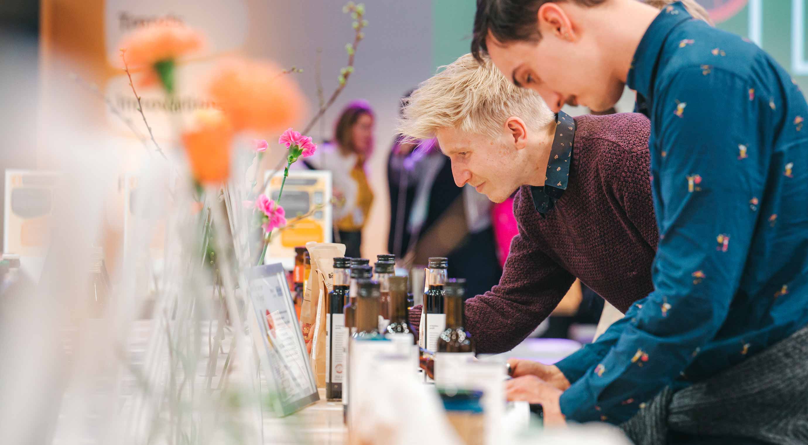 Two people check out the new products at the BIOFACH innovation stand